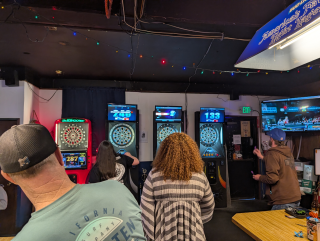 Players throwing darts at Waterfront Tavern dive bar Bellingham
